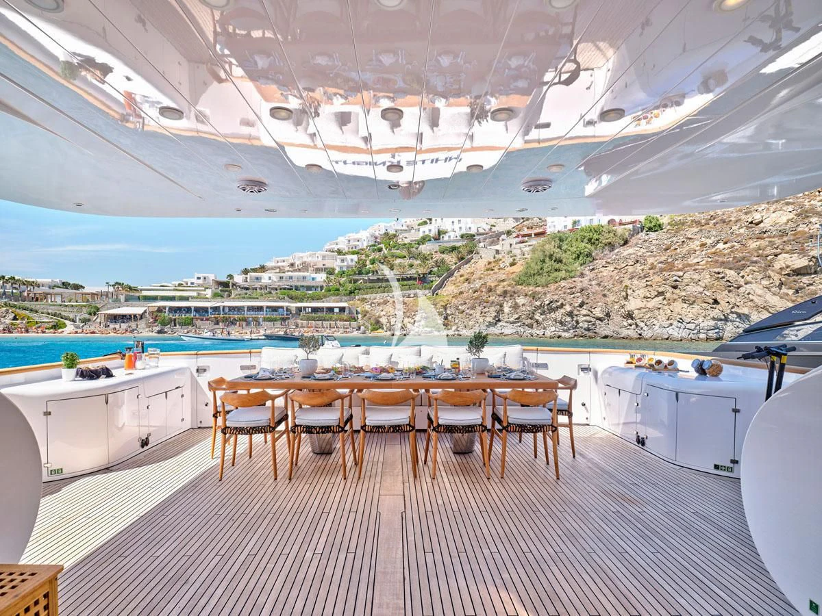 a room with a table and chairs aboard WHITE KNIGHT Yacht for Sale
