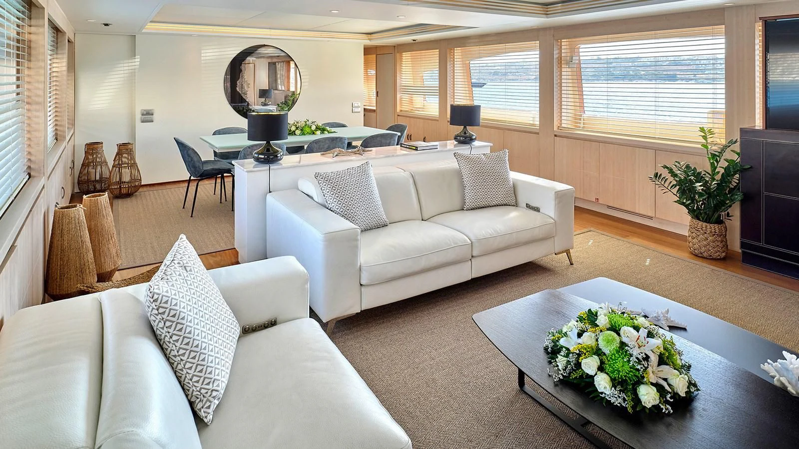 a living room with a white couch and a table with flowers aboard WHITE KNIGHT Yacht for Sale