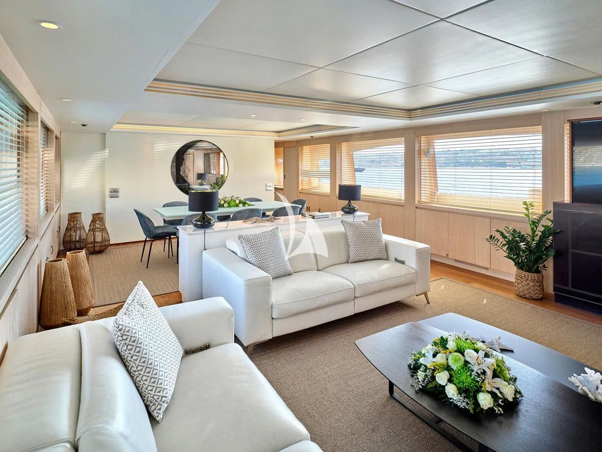 a living room with a white couch and a table aboard WHITE KNIGHT Yacht for Sale