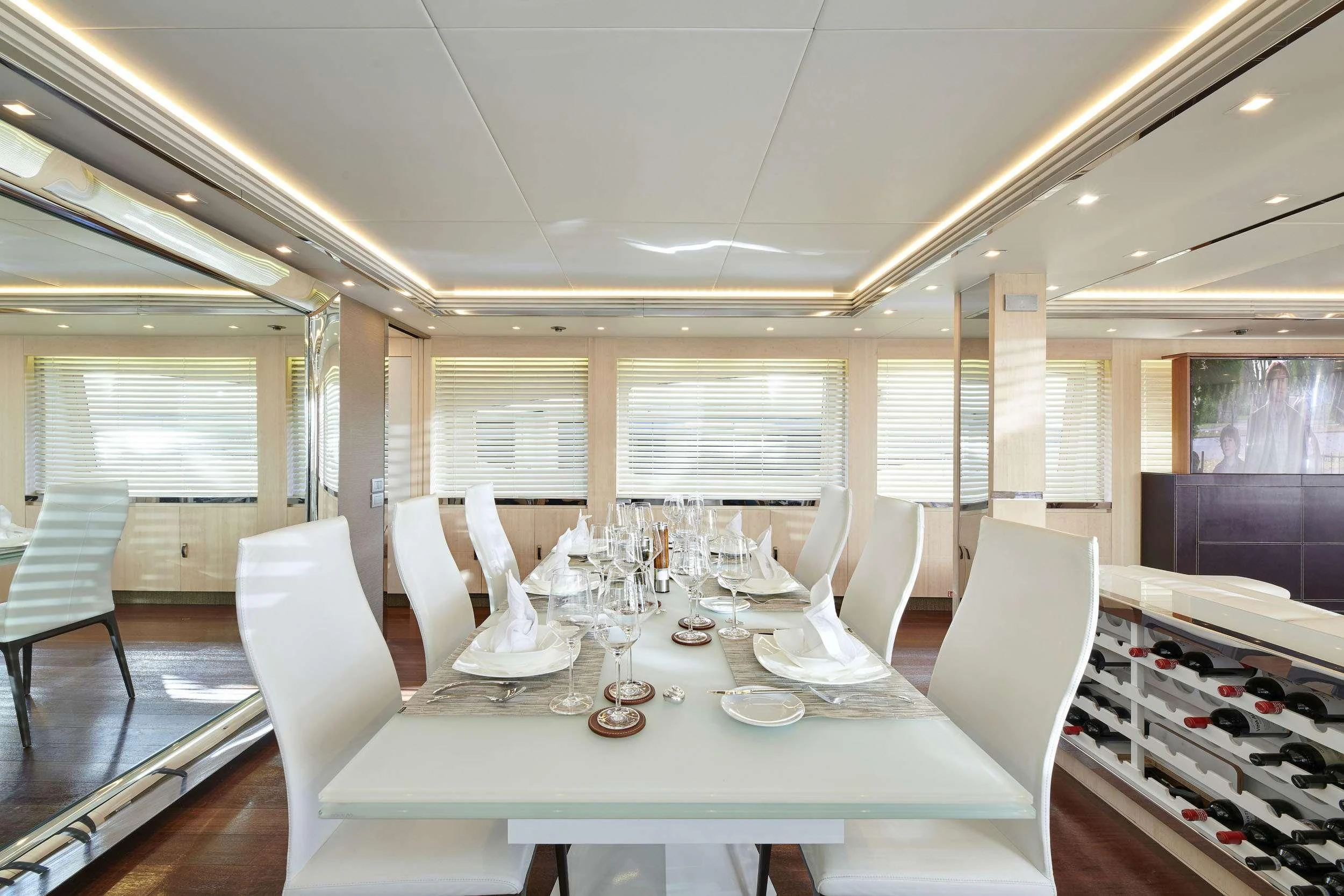 a room with a table chairs and a window aboard WHITE KNIGHT Yacht for Sale