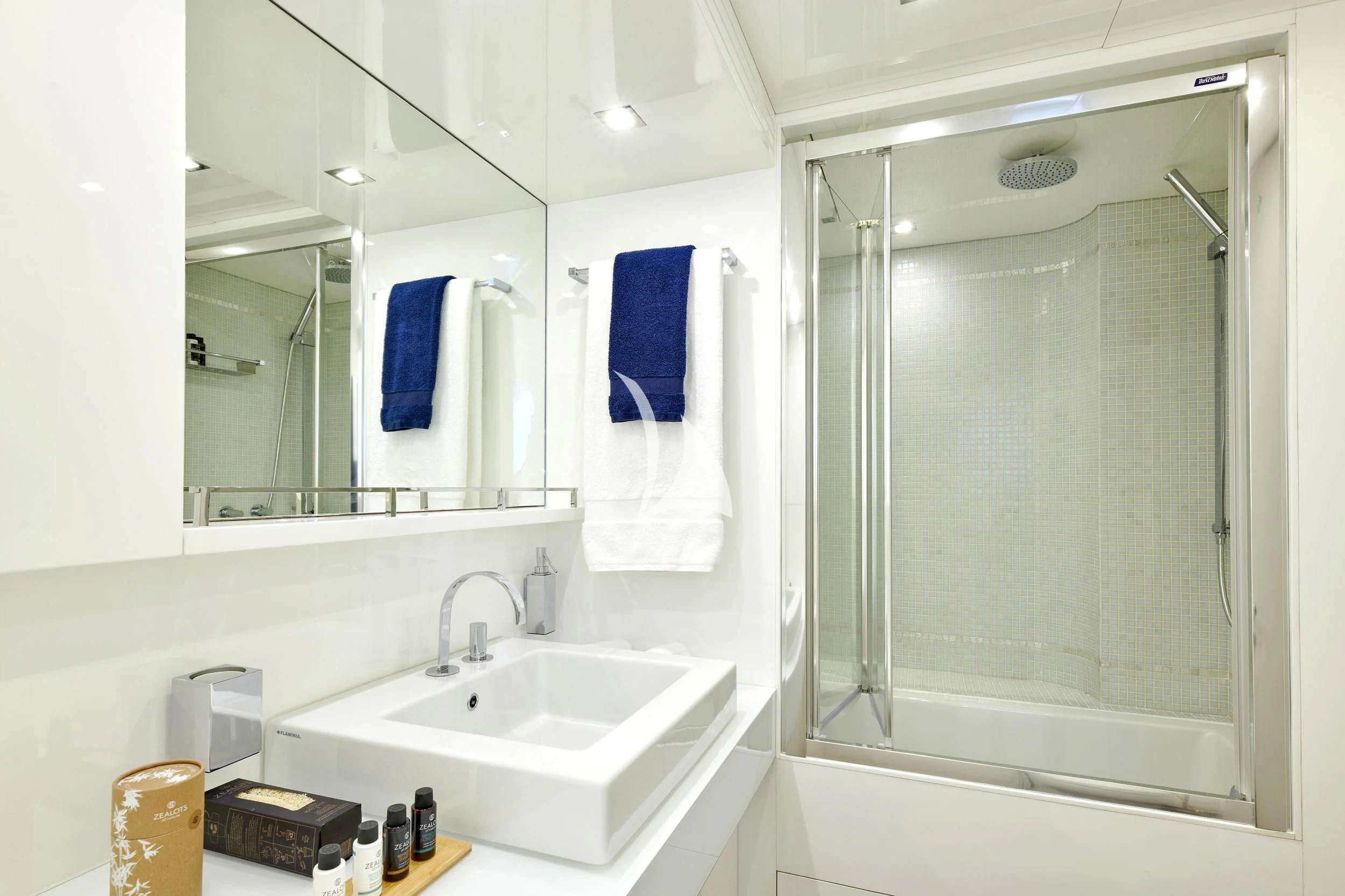 a bathroom with a shower sink and mirror aboard WHITE KNIGHT Yacht for Sale