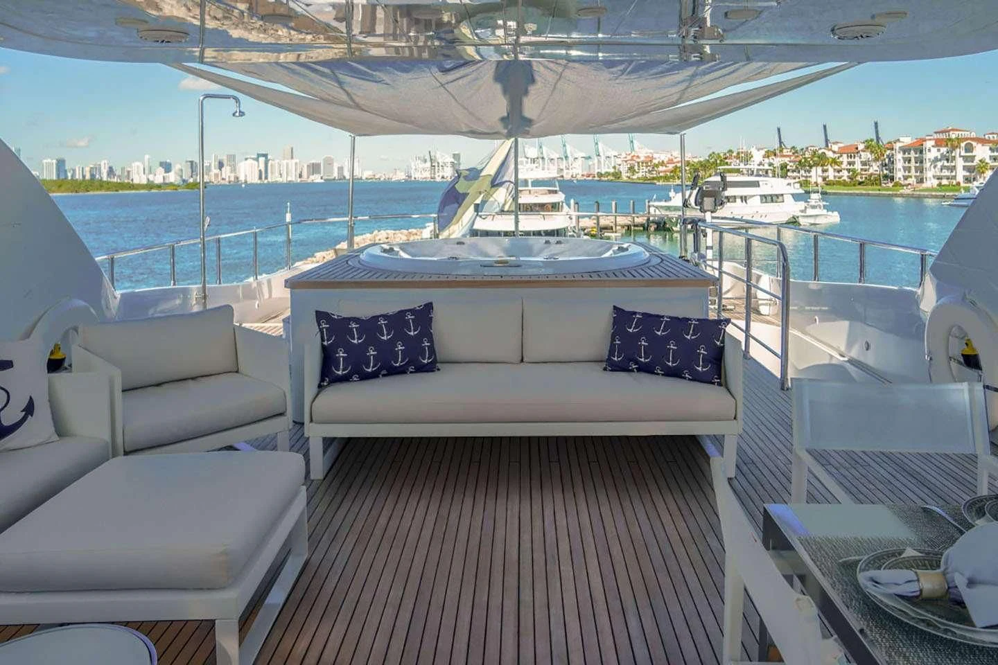 a white couch on a deck overlooking a body of water aboard WHITE KNIGHT Yacht for Sale