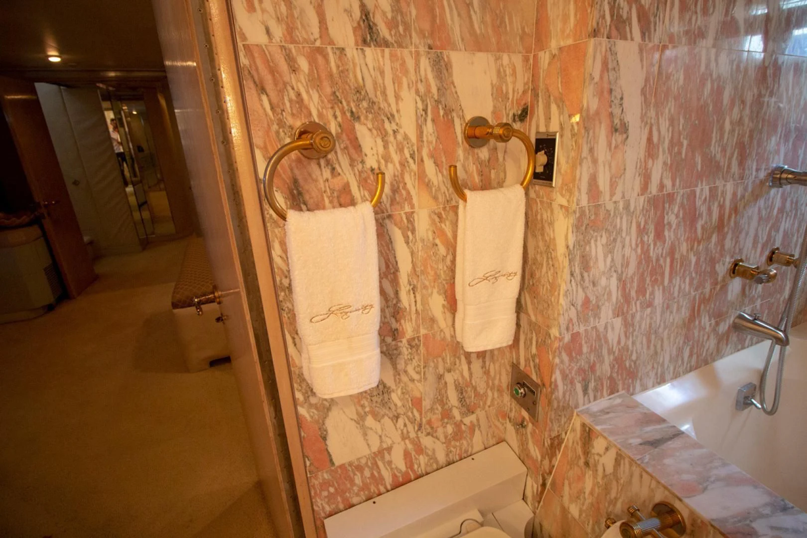 a bathroom with a bathtub and toilet aboard LIQUIDITY Yacht for Sale