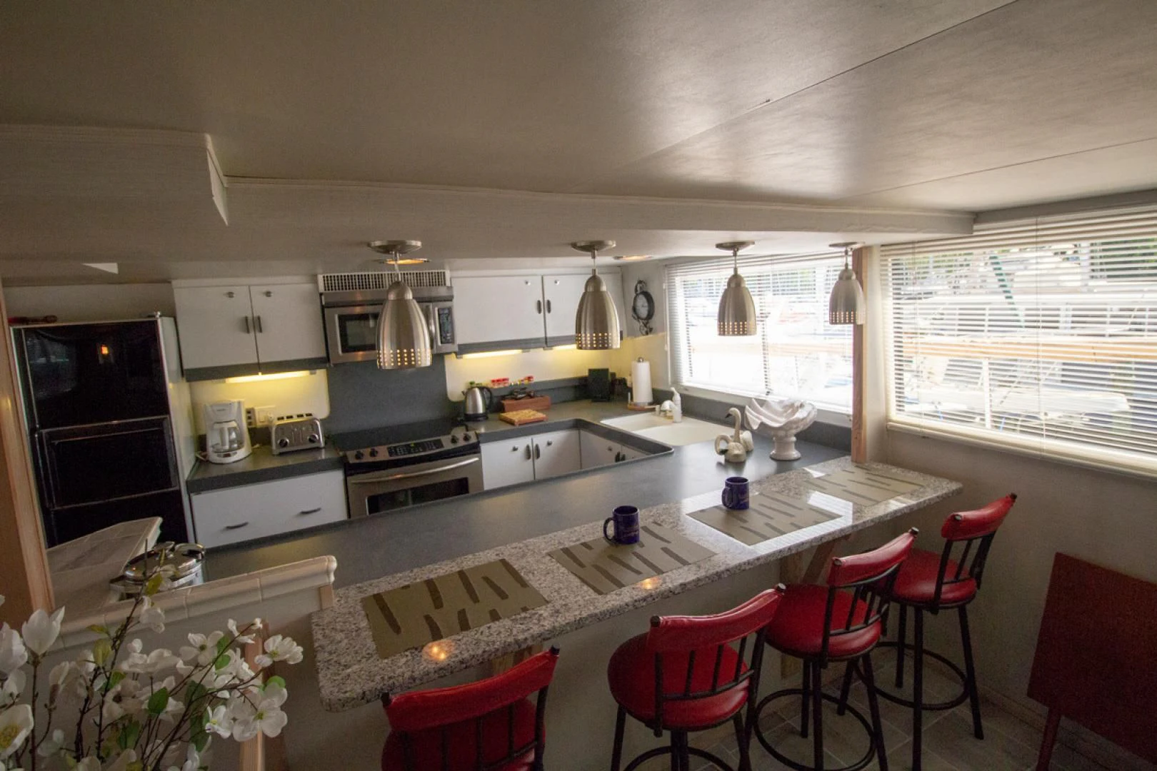 a kitchen with white cabinets aboard LIQUIDITY Yacht for Sale