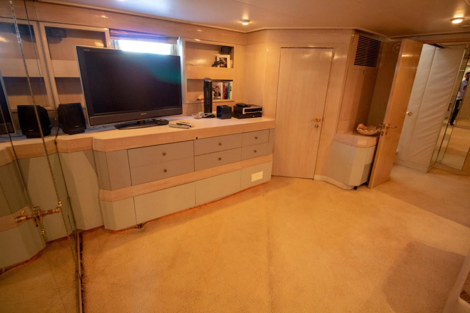 a room with a tv and a dresser aboard LIQUIDITY Yacht for Sale
