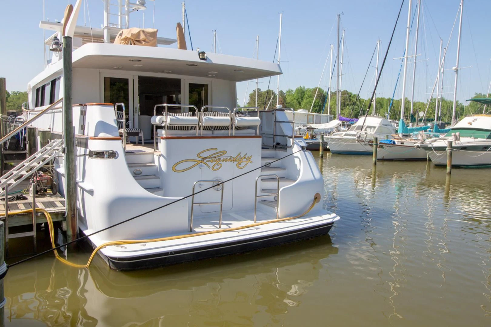 a boat docked at a pier aboard LIQUIDITY Yacht for Sale