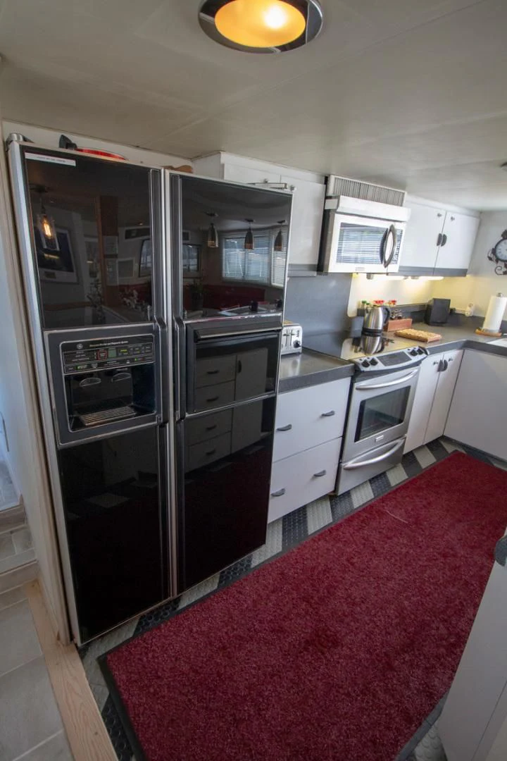 a kitchen with a red rug aboard LIQUIDITY Yacht for Sale