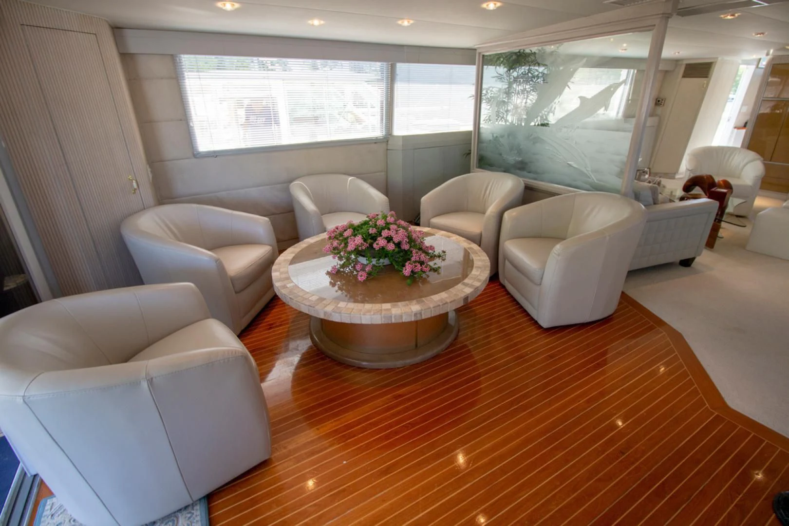 a living room with a table and chairs aboard LIQUIDITY Yacht for Sale