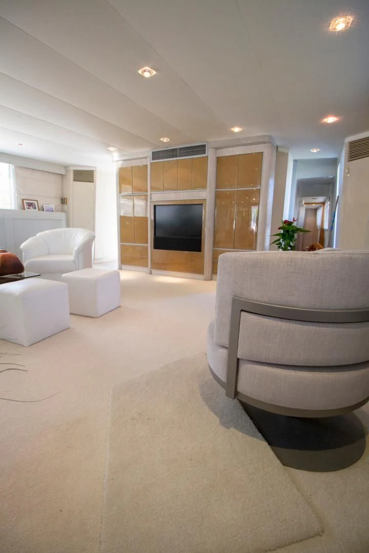 a living room with a fireplace aboard LIQUIDITY Yacht for Sale