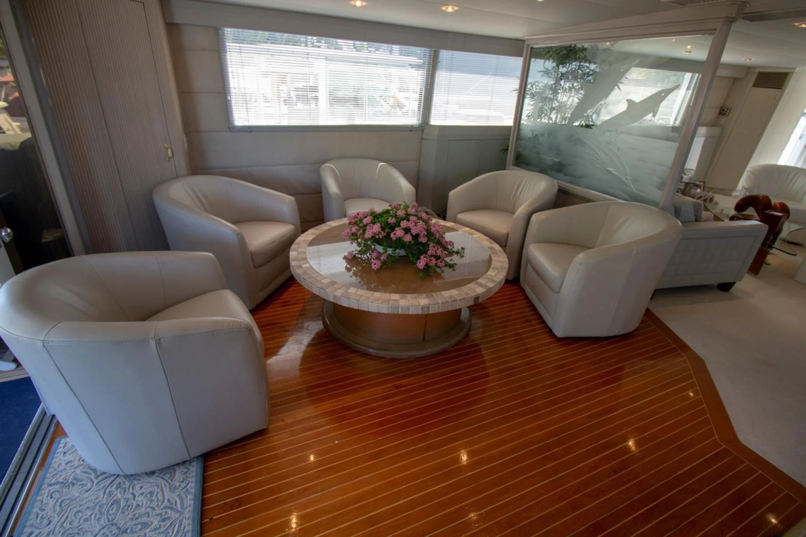 a living room with a table and chairs aboard LIQUIDITY Yacht for Sale