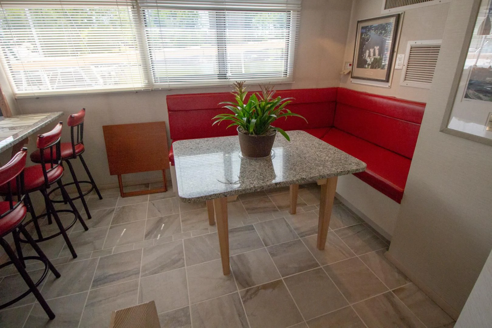 a table with a plant on it aboard LIQUIDITY Yacht for Sale