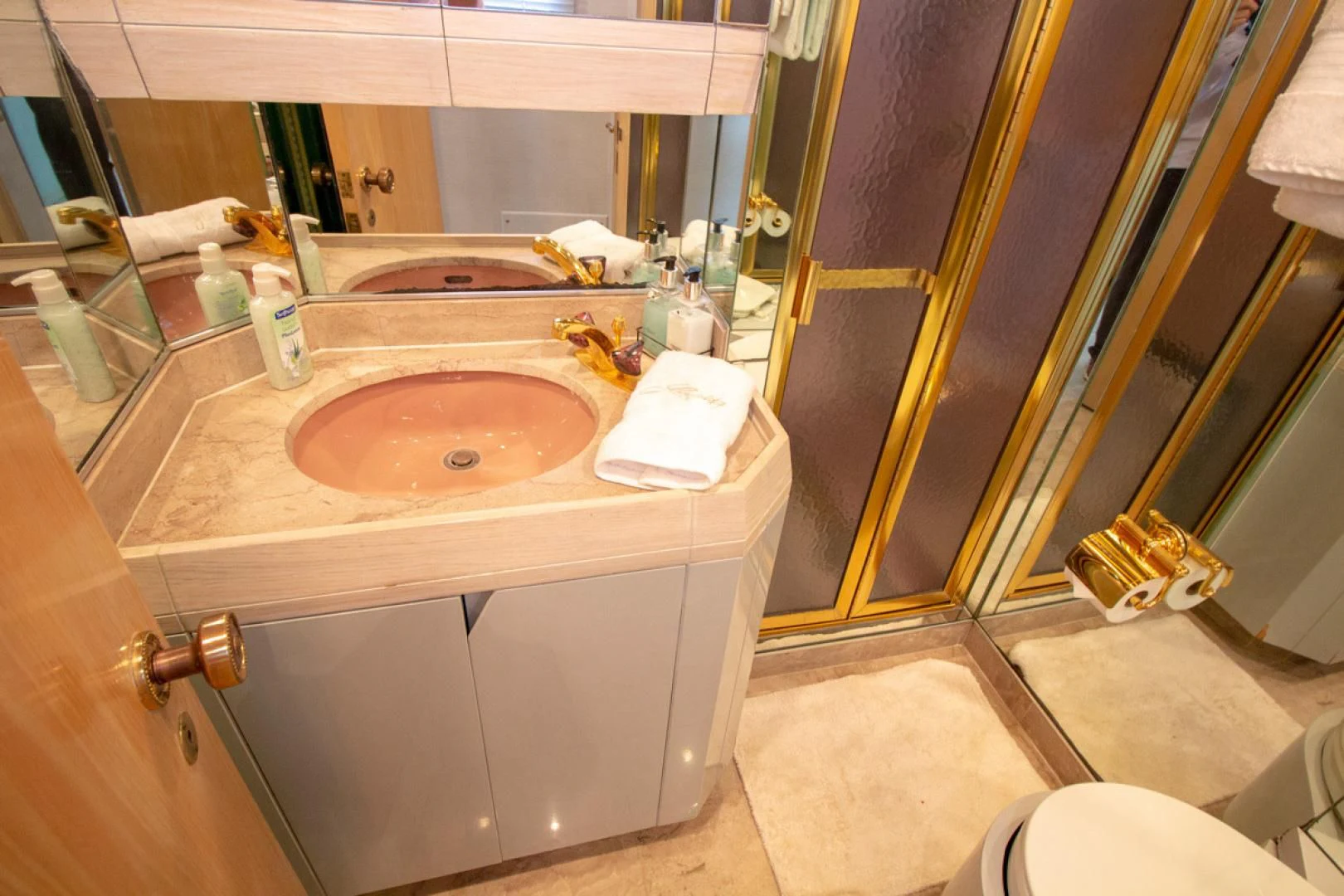 a bathroom with a sink and a mirror aboard LIQUIDITY Yacht for Sale