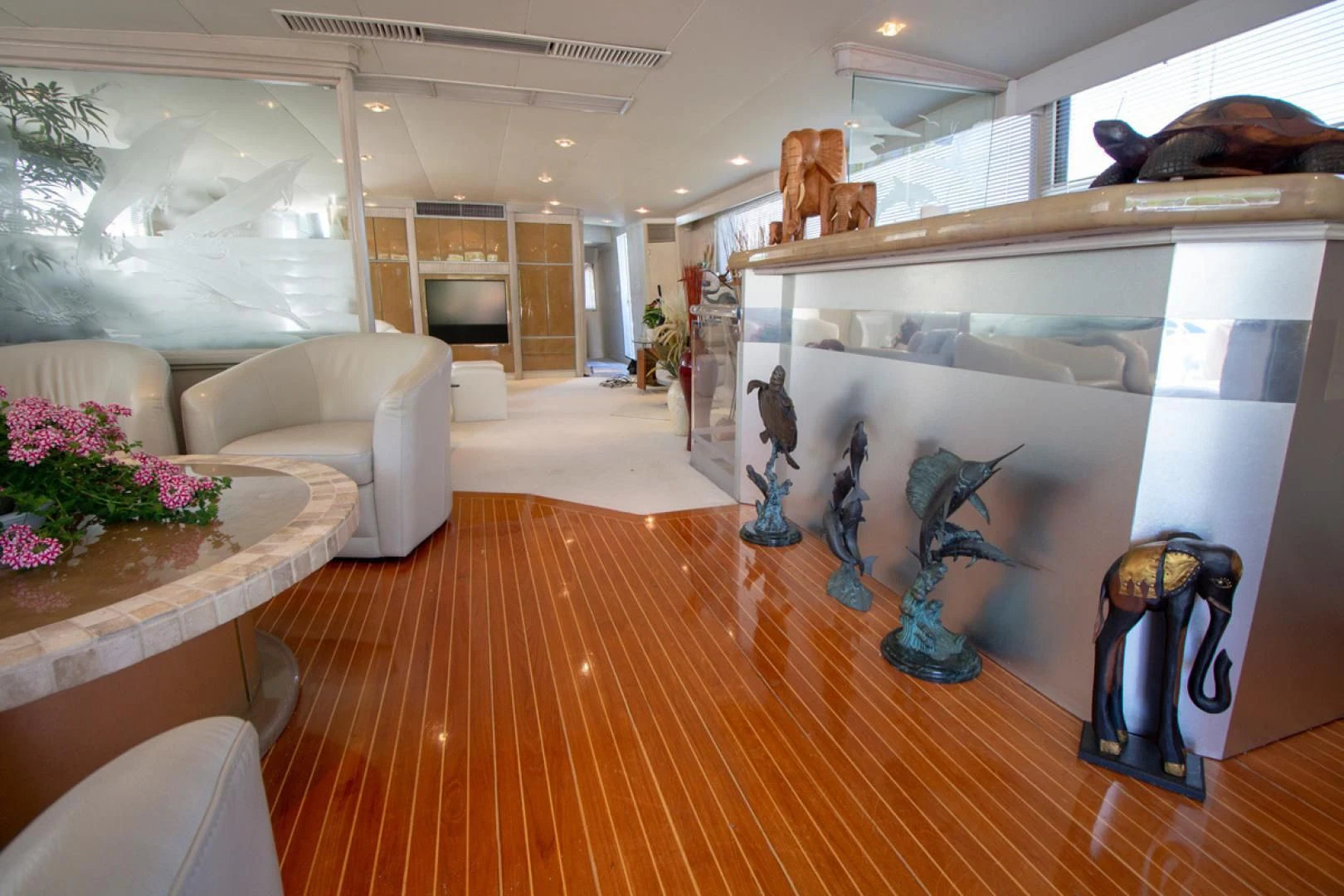 a room with a table and couches aboard LIQUIDITY Yacht for Sale