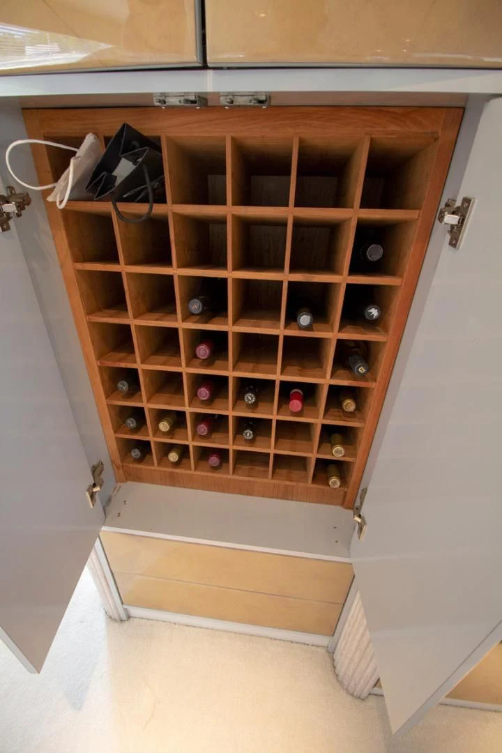 a cabinet with many bottles in it aboard LIQUIDITY Yacht for Sale