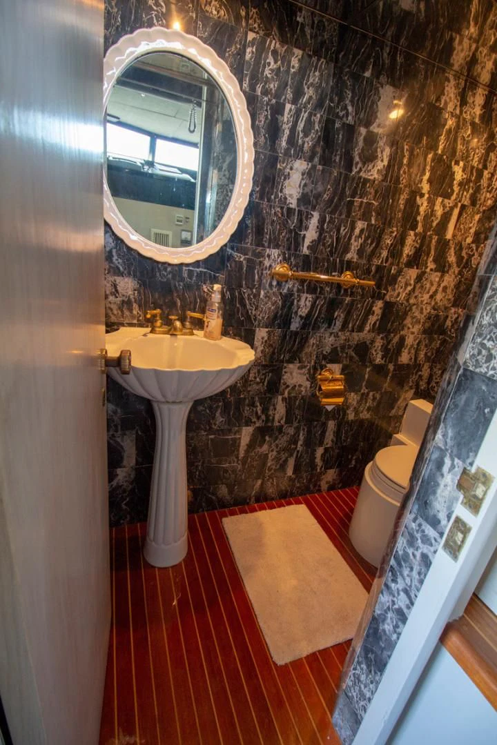 a bathroom with a sink and a mirror aboard LIQUIDITY Yacht for Sale