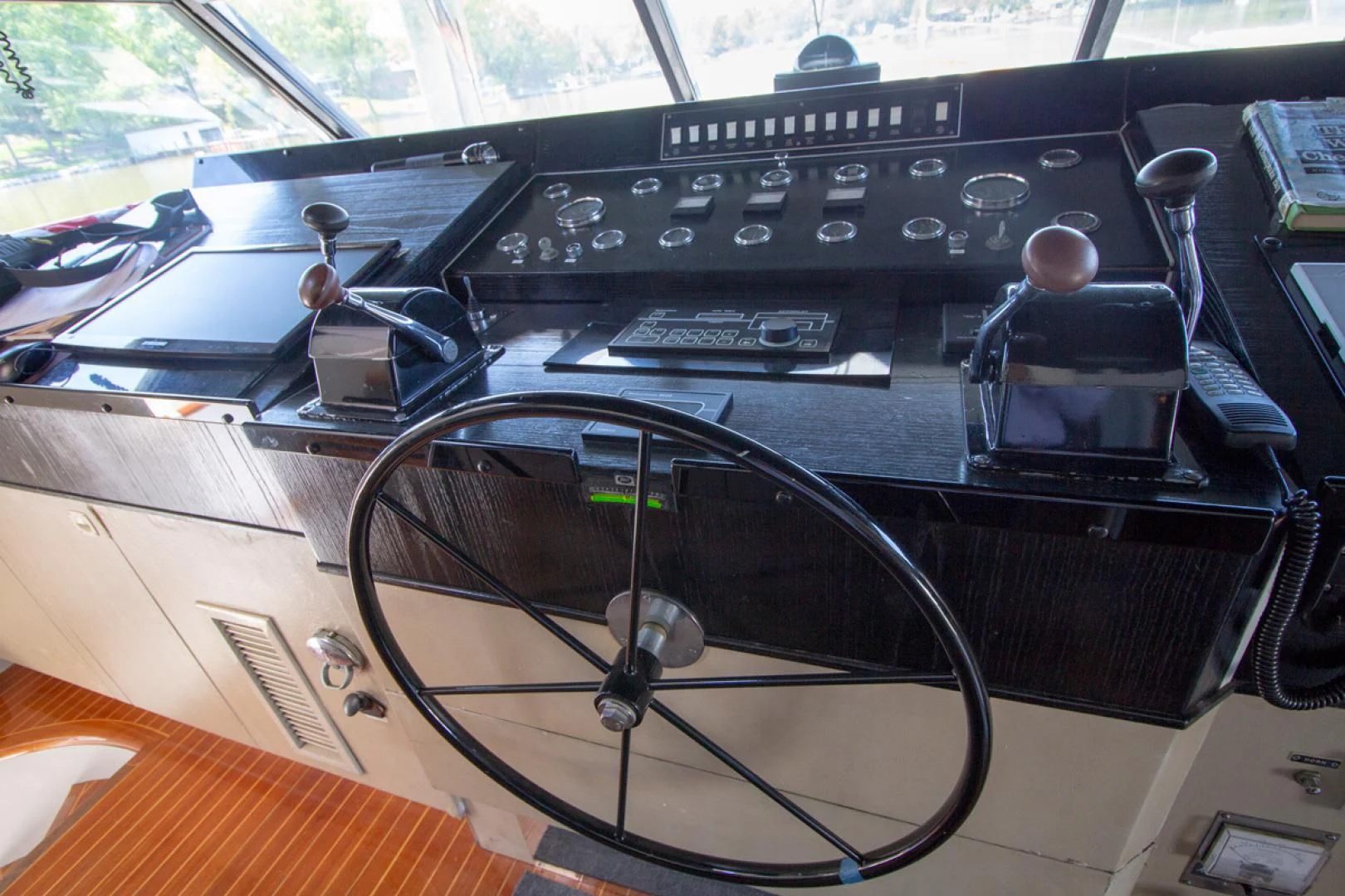 a black electronic device on a wooden surface aboard LIQUIDITY Yacht for Sale