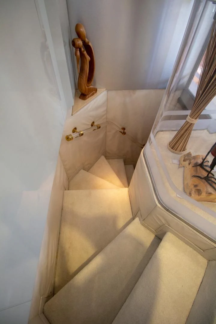 a cat sitting on a staircase aboard LIQUIDITY Yacht for Sale