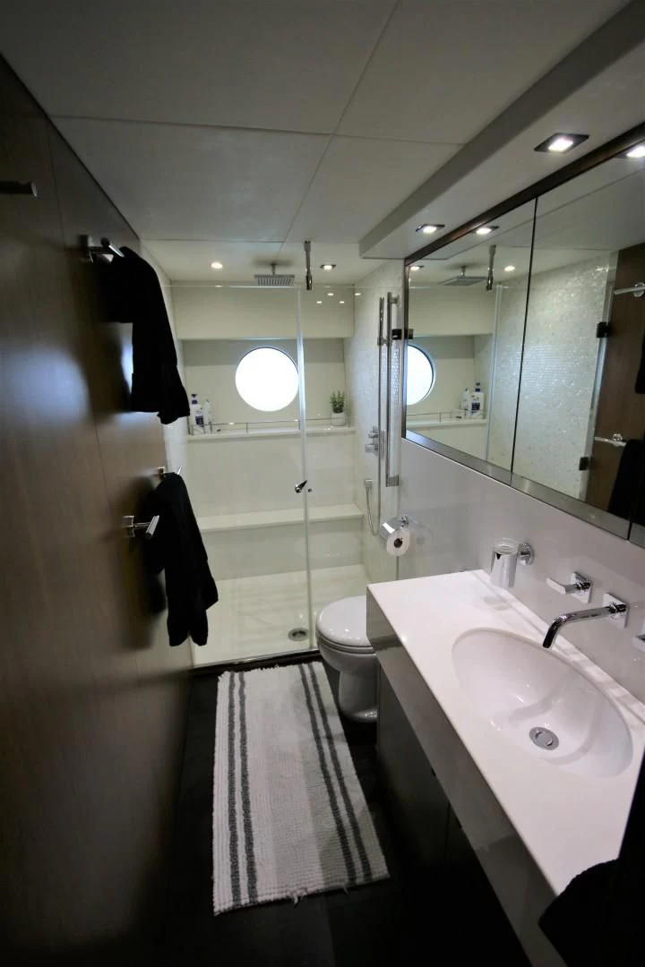 a bathroom with a large mirror aboard SAVI II Yacht for Sale