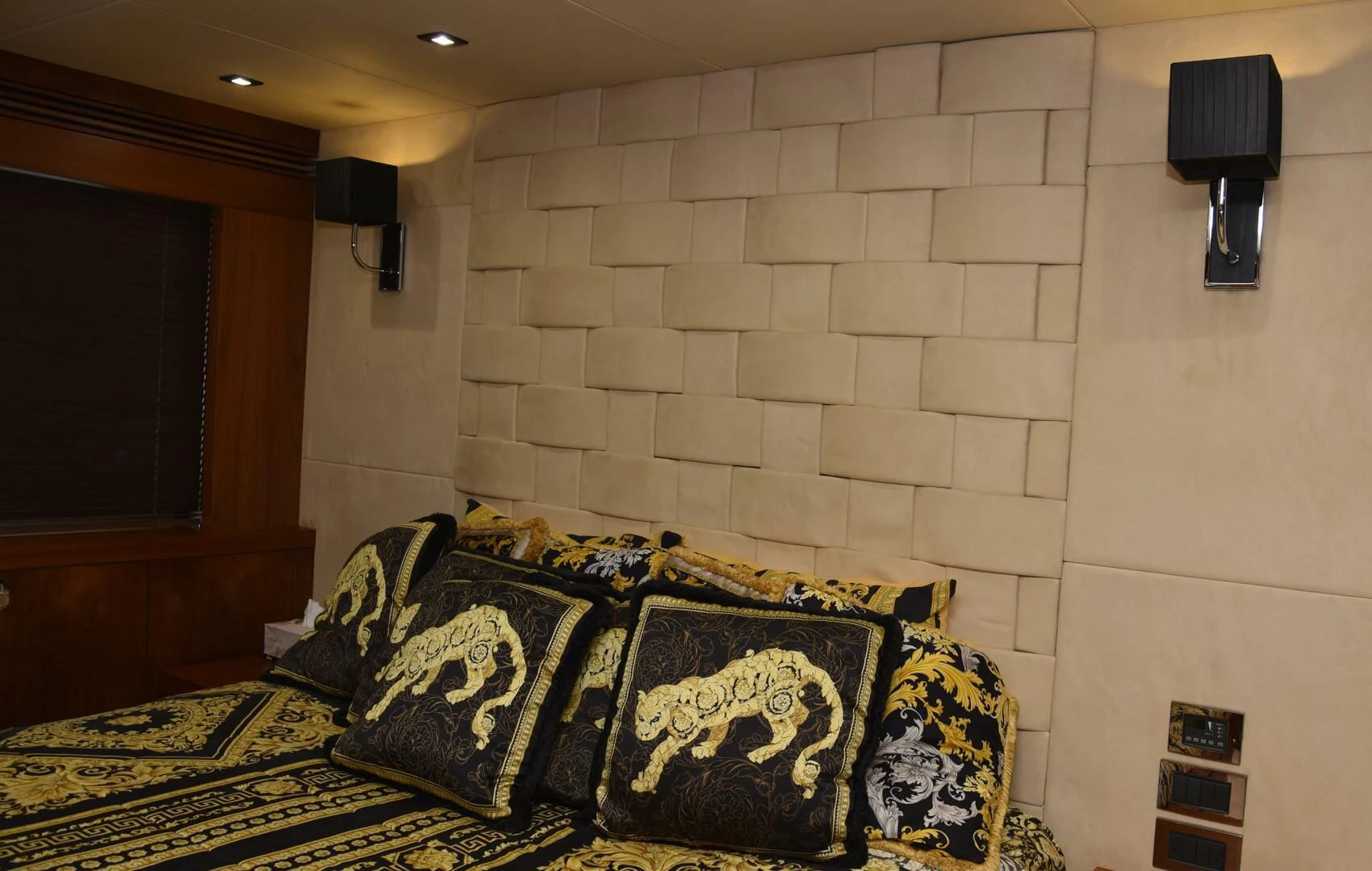 a room with a couch and a lamp on the wall aboard SAVI II Yacht for Sale