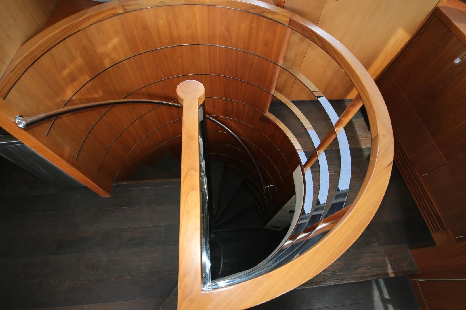 a wooden spiral staircase aboard SAVI II Yacht for Sale