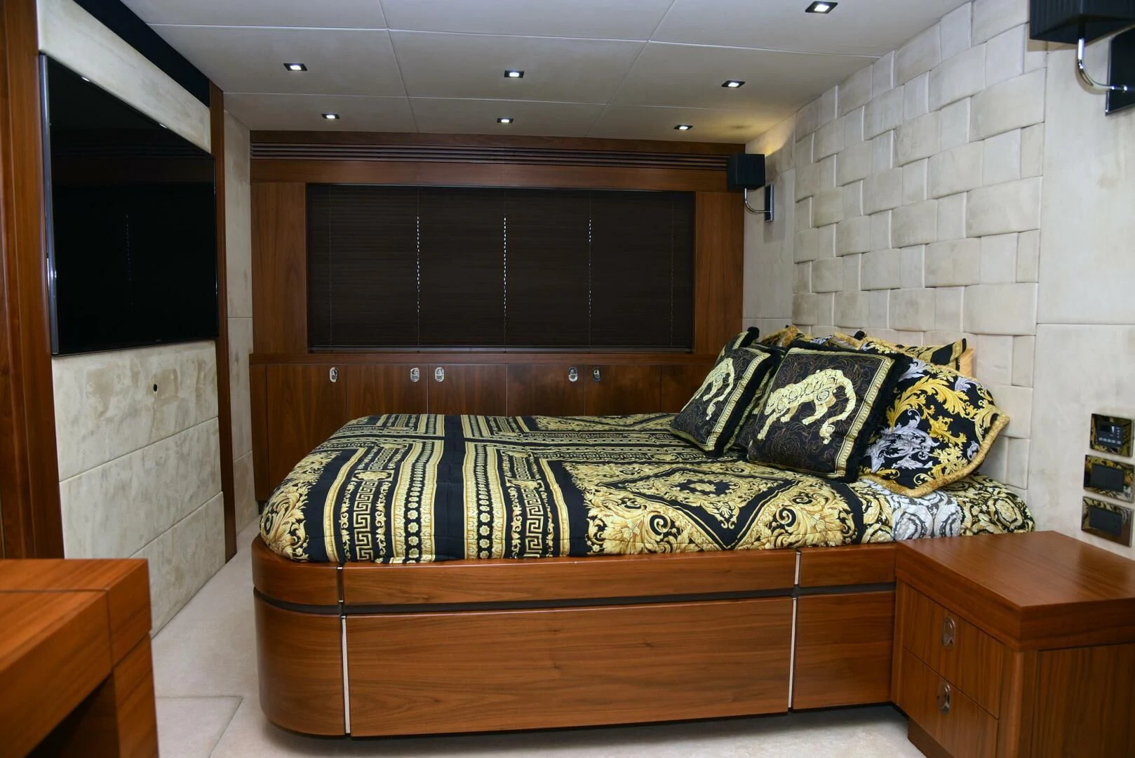 a bed with a blue and black blanket on it aboard SAVI II Yacht for Sale