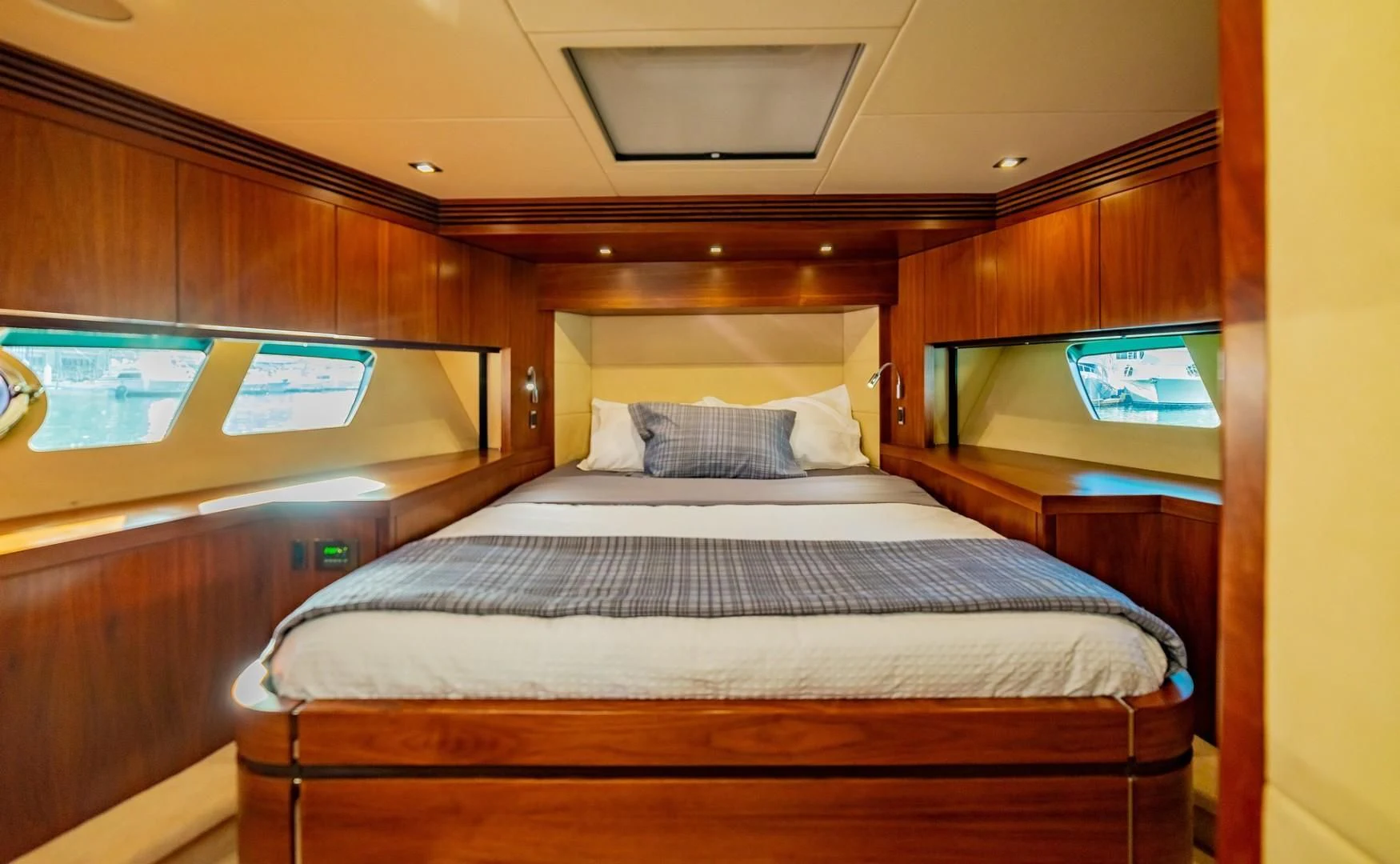 a bed with a television on the wall aboard SAVI II Yacht for Sale