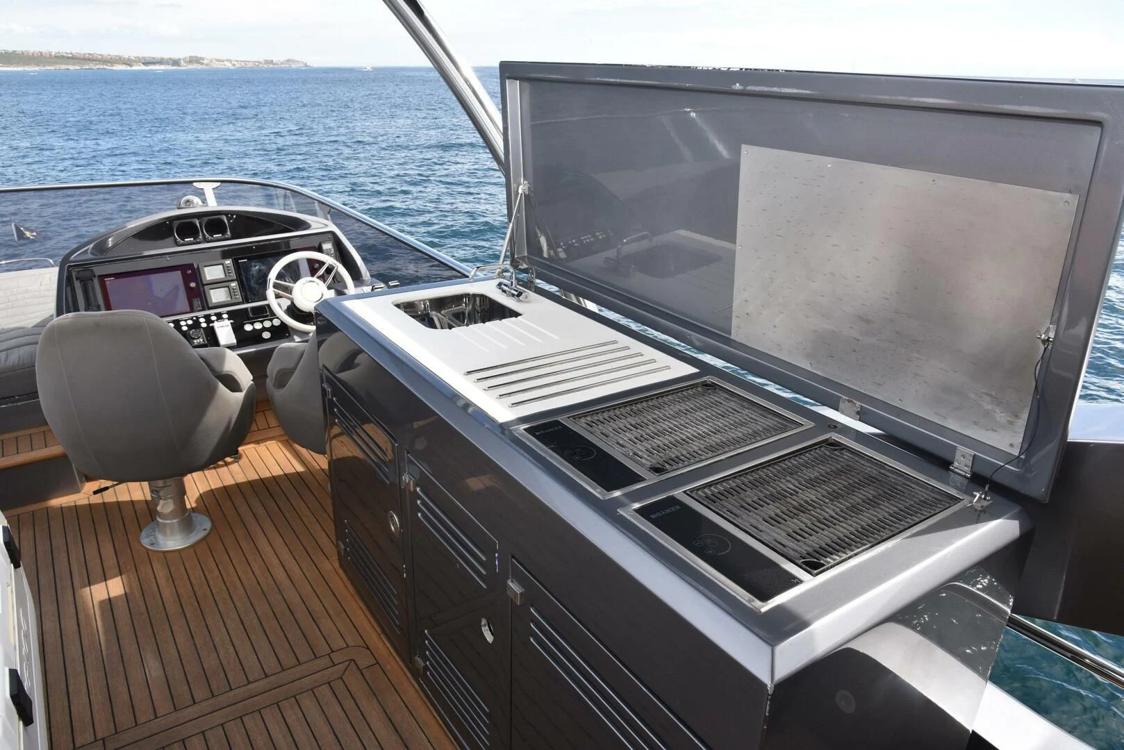 a deck with a large tv and a chair on it aboard SAVI II Yacht for Sale