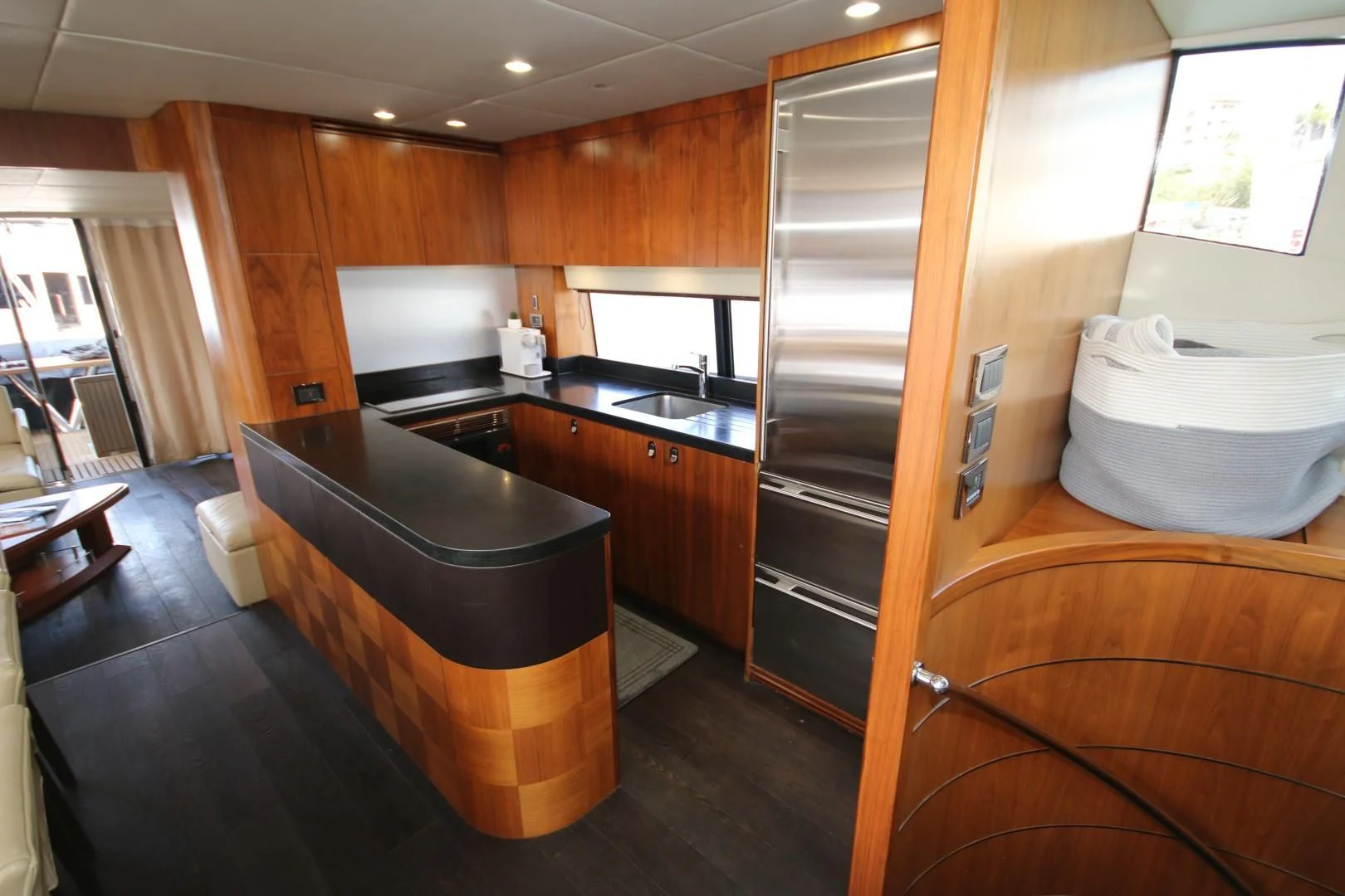 a kitchen with a large bar and a large refrigerator aboard SAVI II Yacht for Sale
