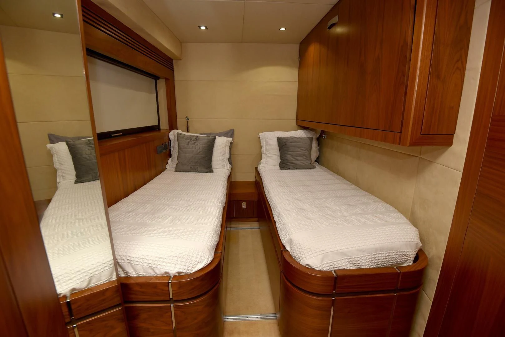 a room with beds and a mirror aboard SAVI II Yacht for Sale