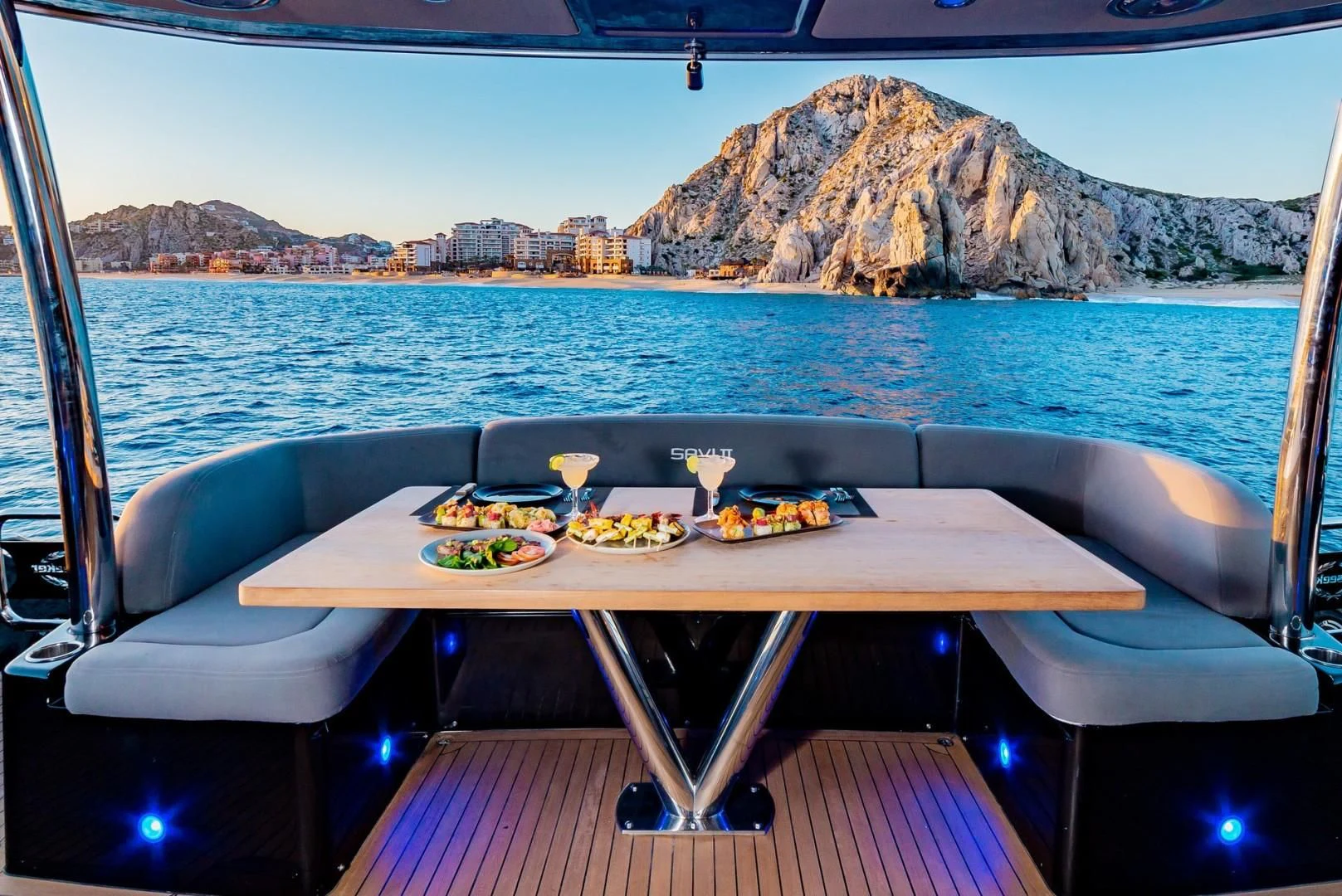 a table with food on it by the water aboard SAVI II Yacht for Sale