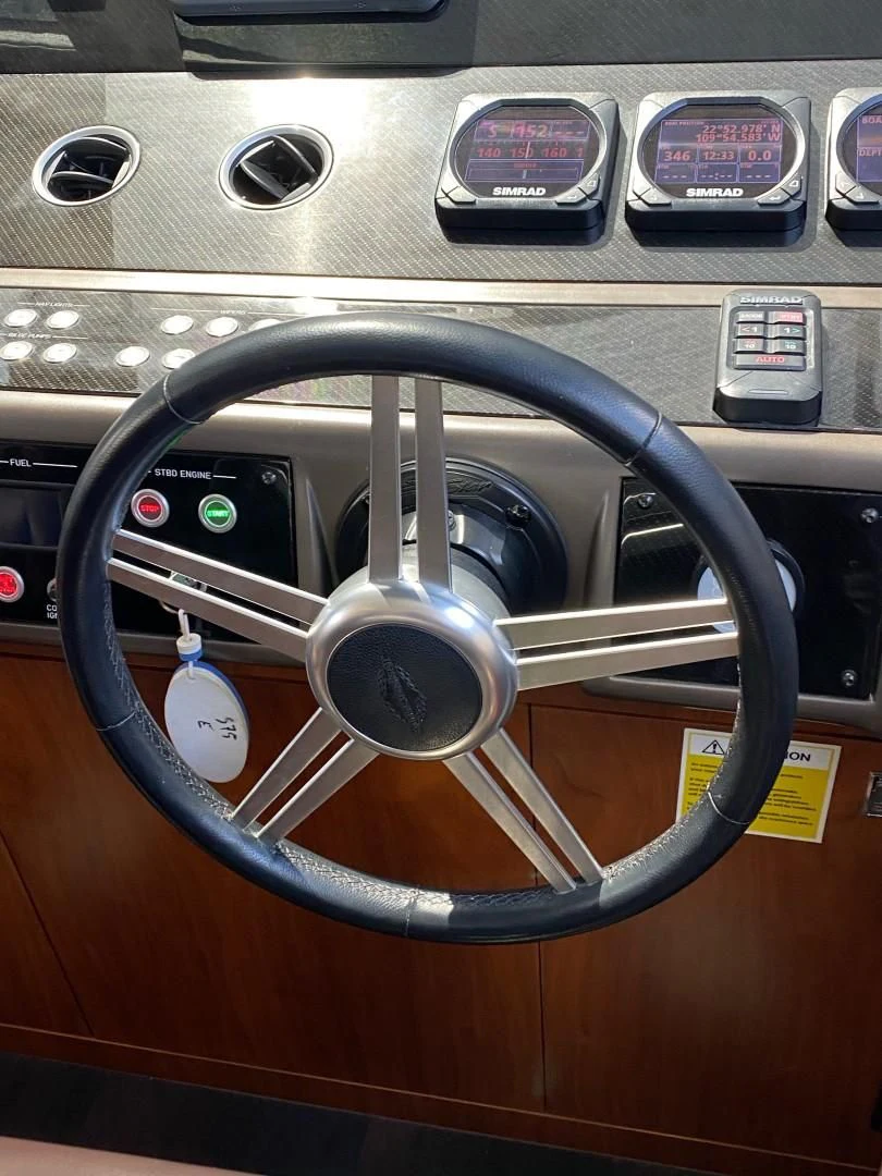 a steering wheel in a car aboard SAVI II Yacht for Sale