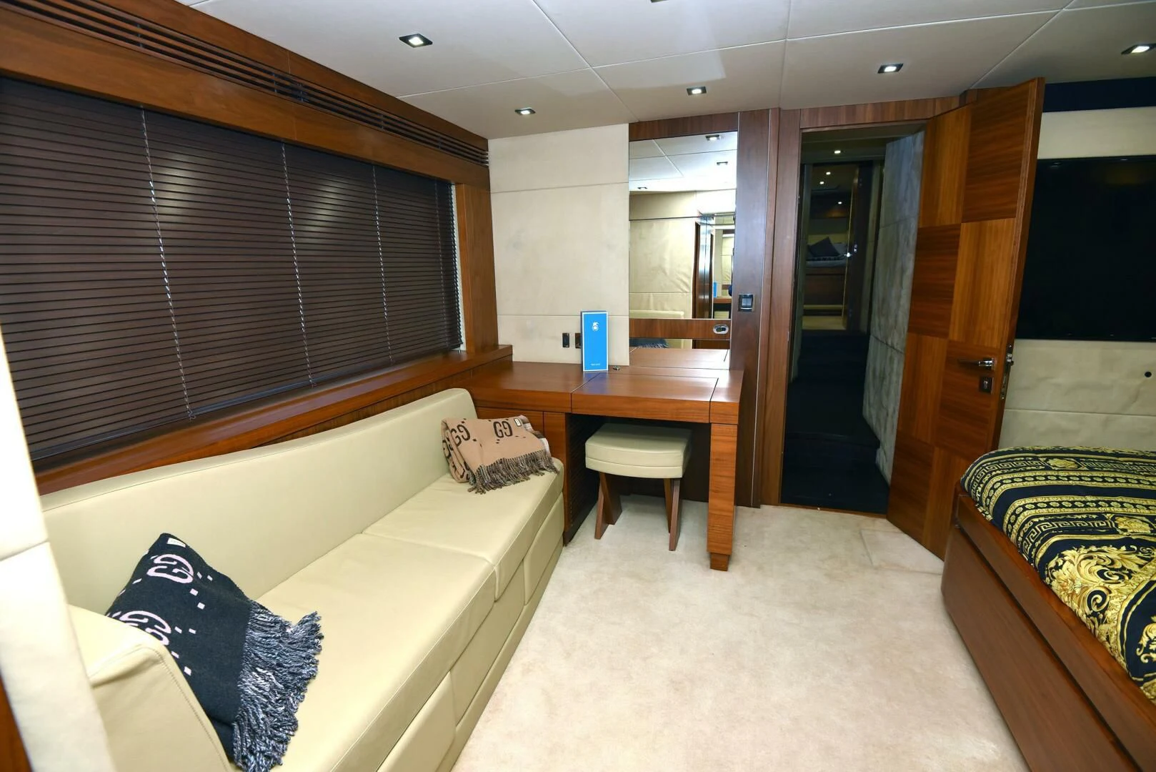 a room with a bed and desk aboard SAVI II Yacht for Sale