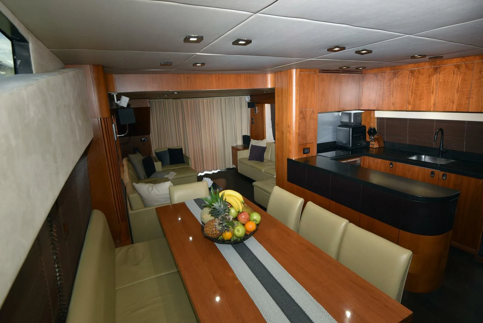 a kitchen with a table and couches aboard SAVI II Yacht for Sale
