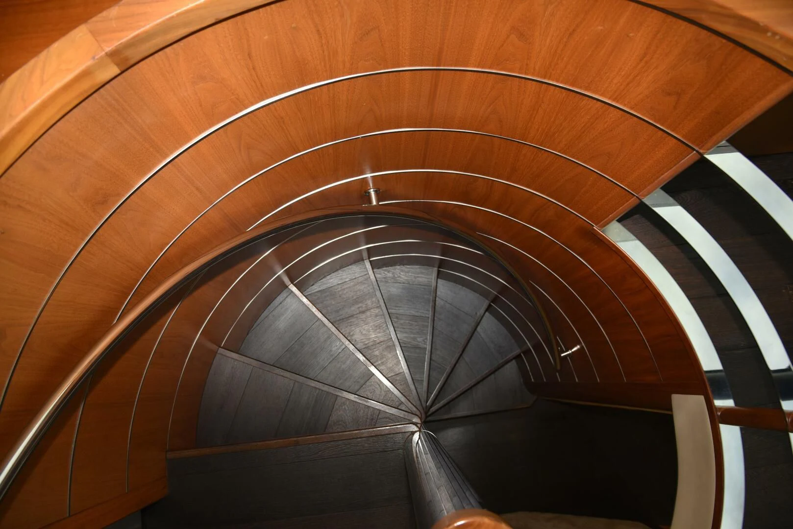 a spiral staircase with a spiral staircase aboard SAVI II Yacht for Sale