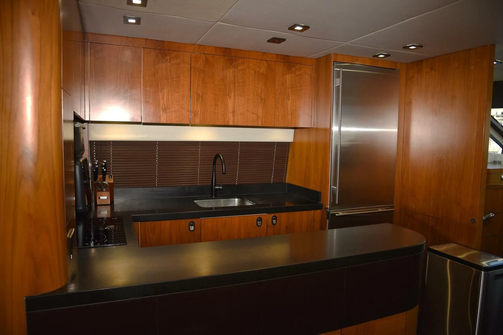 a kitchen with wooden cabinets aboard SAVI II Yacht for Sale