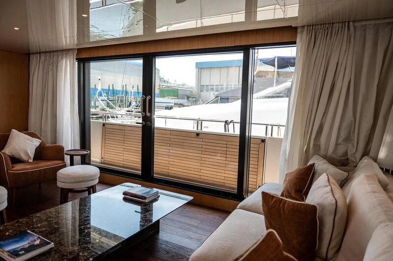 a living room with a large window aboard VISSOTTA Yacht for Sale