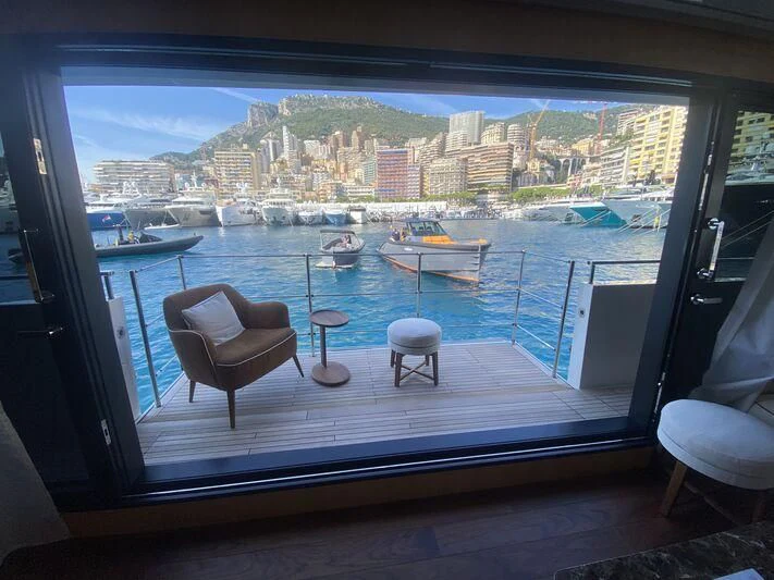a room with a view of a city and boats in it aboard VISSOTTA Yacht for Sale