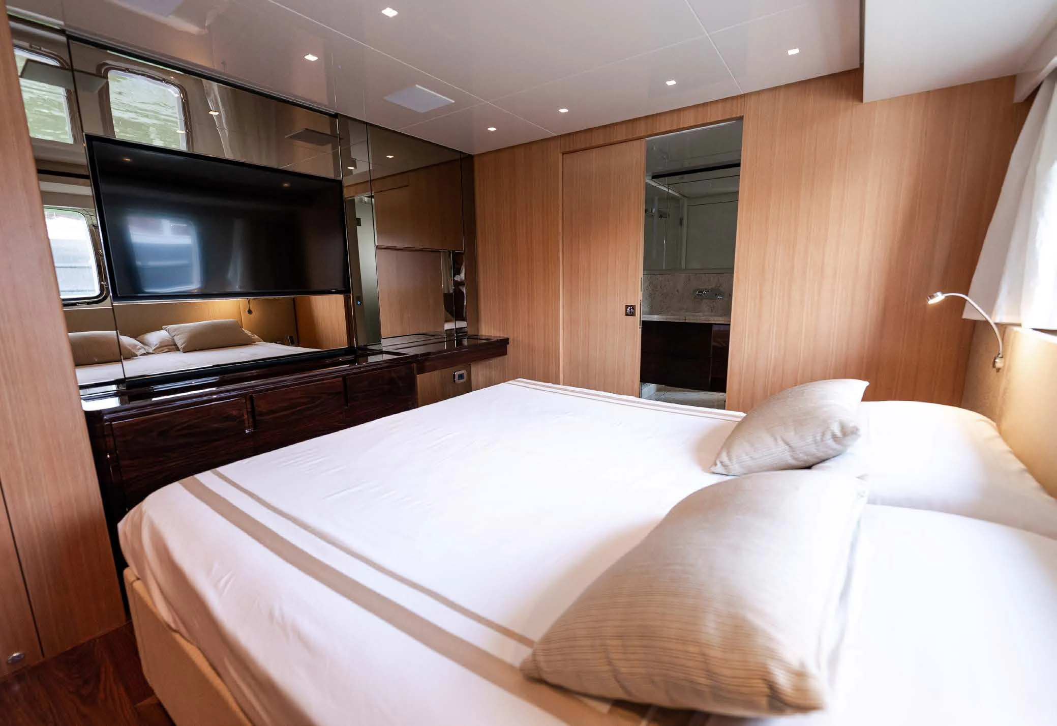 a room with a bed and a television aboard VISSOTTA Yacht for Sale