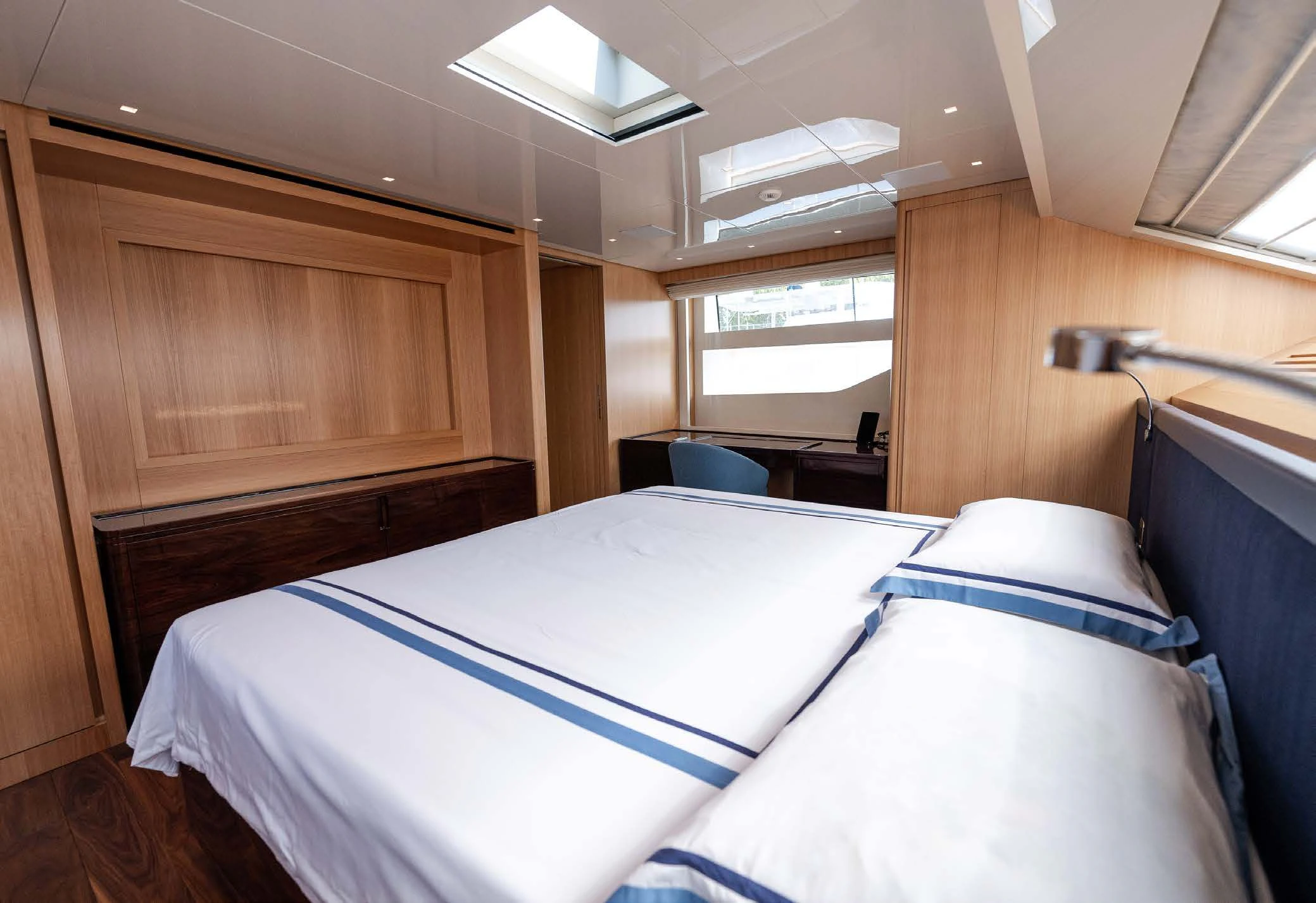 a room with a bed and a desk aboard VISSOTTA Yacht for Sale