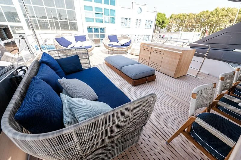 a deck with a couch and a table and chairs aboard VISSOTTA Yacht for Sale