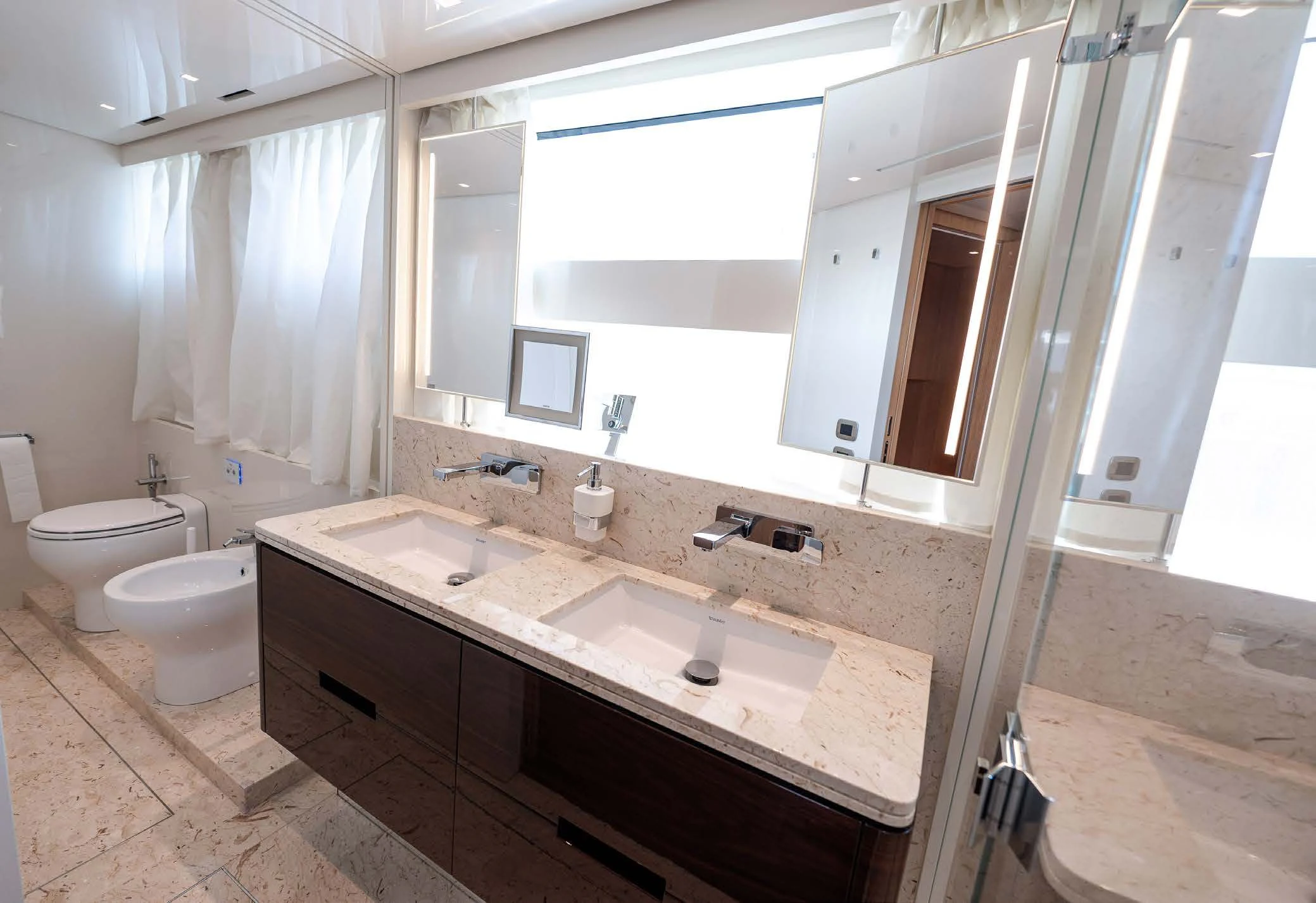 a bathroom with a large mirror aboard VISSOTTA Yacht for Sale