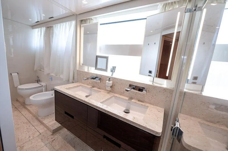 a bathroom with a large mirror aboard VISSOTTA Yacht for Sale