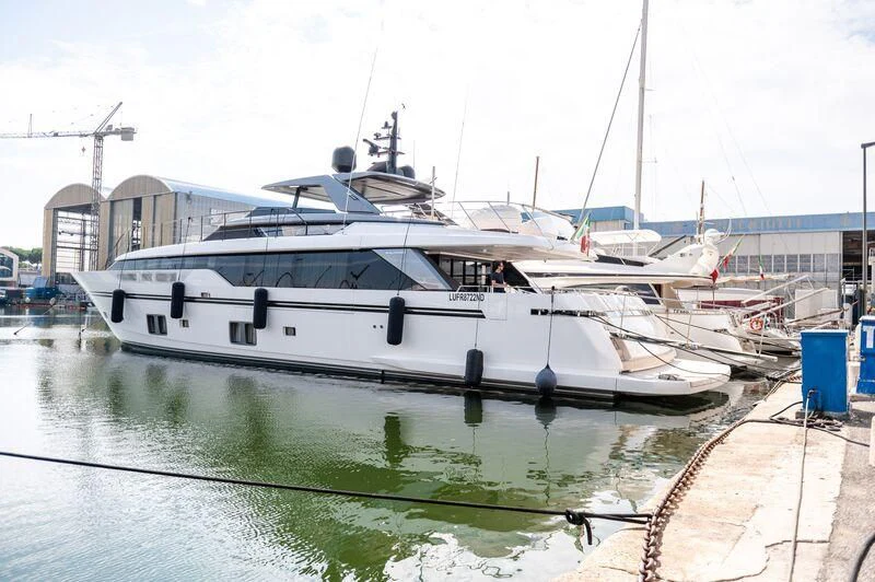 a white boat in a harbor aboard VISSOTTA Yacht for Sale