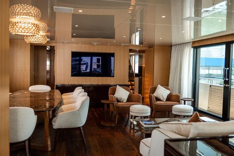 a room with tables chairs and a television aboard VISSOTTA Yacht for Sale