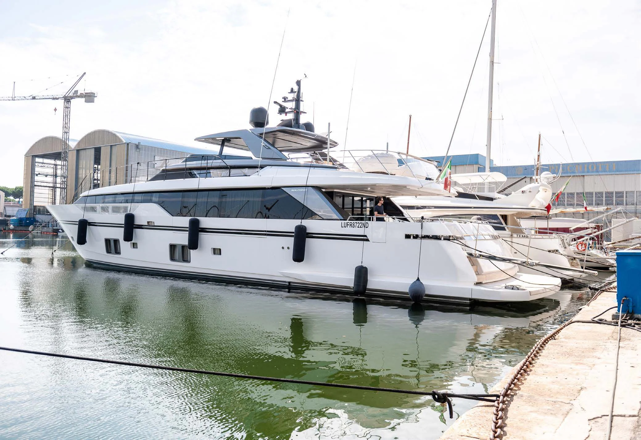 a white boat in a harbor aboard VISSOTTA Yacht for Sale
