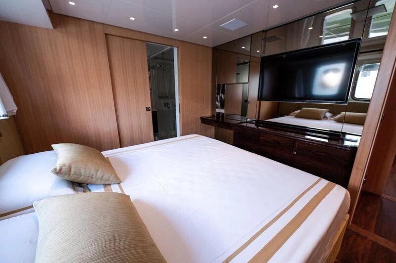 a room with a bed and a television aboard VISSOTTA Yacht for Sale