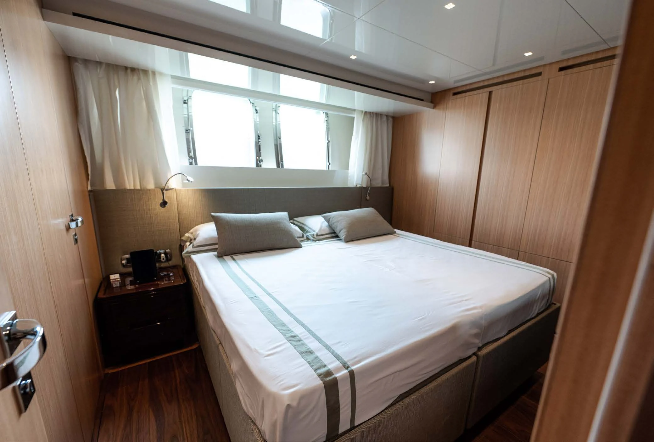 a room with a bed and a window aboard VISSOTTA Yacht for Sale