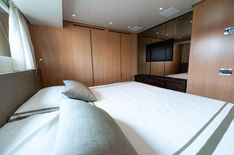 a bed with white sheets aboard VISSOTTA Yacht for Sale