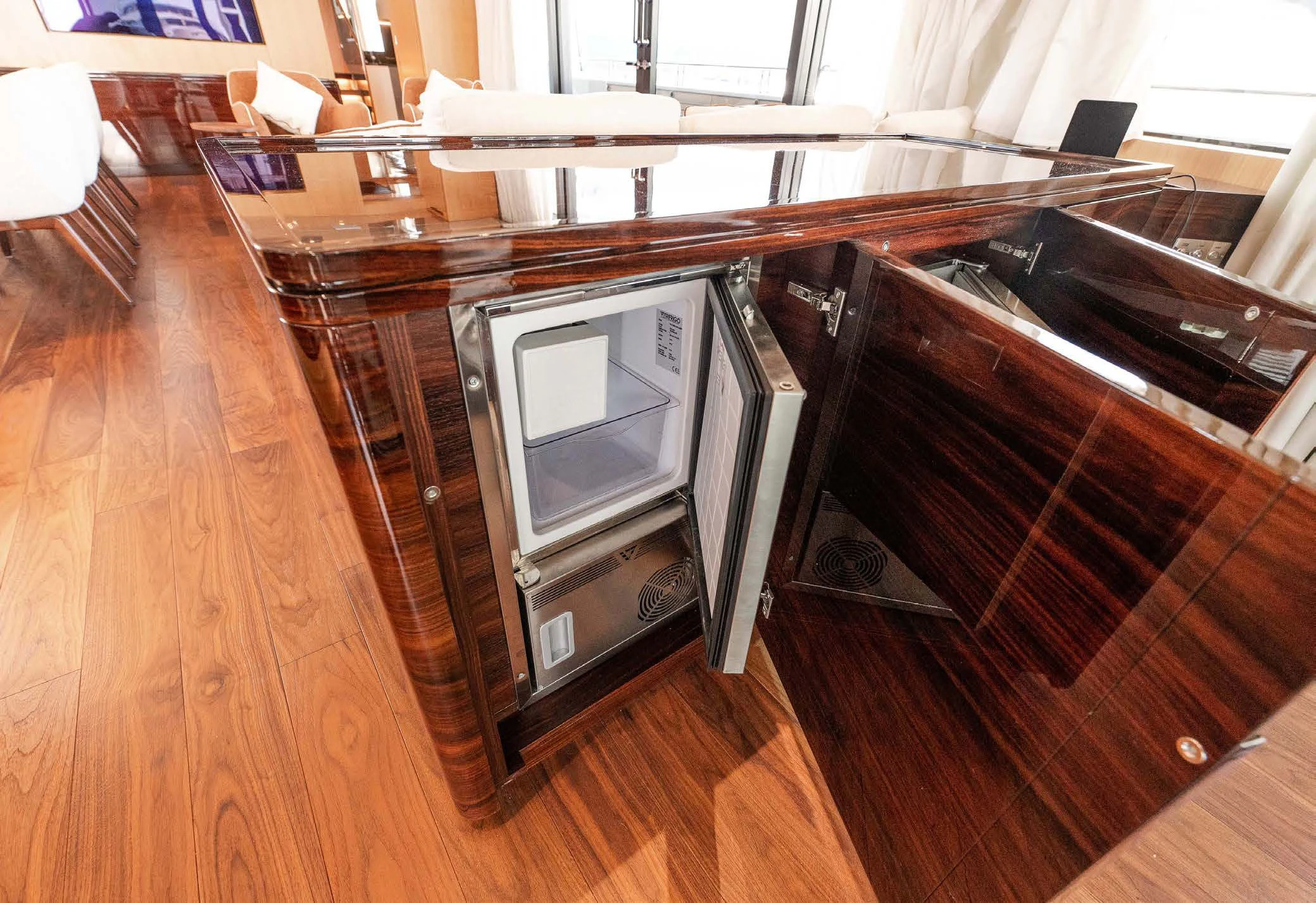a microwave oven sits on a wooden table aboard VISSOTTA Yacht for Sale