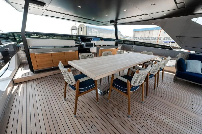 a large room with a table and chairs aboard VISSOTTA Yacht for Sale